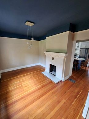 Victoria apartment for rent - A room with a fireplace and wooden floors.