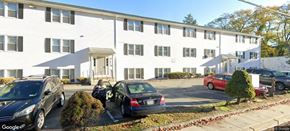 North Providence apartment for rent - A white building with a black car parked in front.