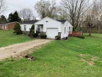 Loveland house for rent - A white house with a garage is surrounded by a green lawn.