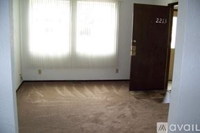 Pekin house for rent - A room with a brown carpet and a brown door with the number 2213 on it.