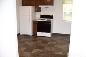 Pekin house for rent - A kitchen with a white fridge and black stove.