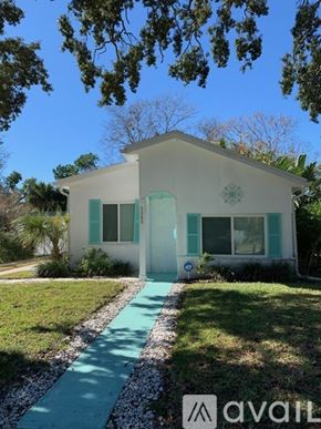 Daytona Beach house for rent - A white house with a green door and windows.