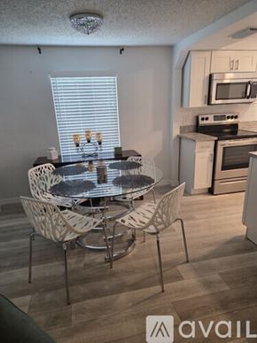 Daytona Beach house for rent - A room with a table, chairs, and a gym equipment.