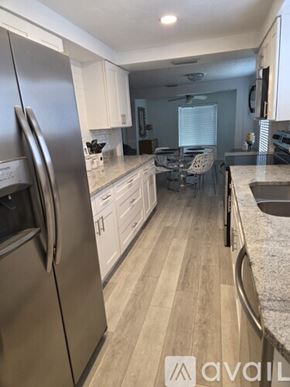 Daytona Beach house for rent - A bedroom with a bed, a nightstand, and a small shelf.