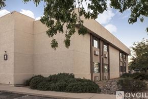 Sierra Vista apartment for rent - A beige building with a tree in front of it.