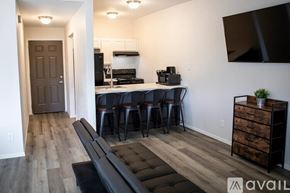 Sierra Vista apartment for rent - A modern kitchen with a bar area and a dining table.