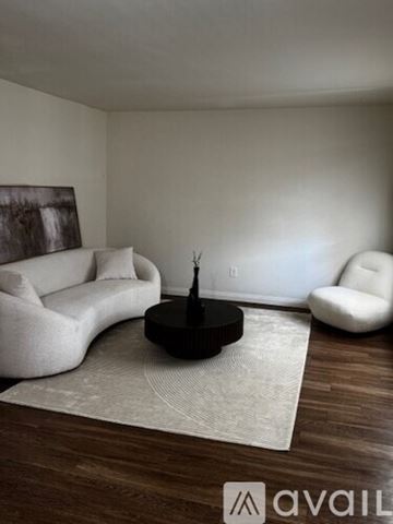 Sierra Vista apartment for rent - A living room with a black couch and a wooden floor.