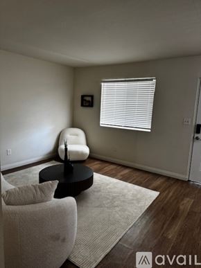 Sierra Vista apartment for rent - A kitchen with a white fridge and a dining table with chairs.