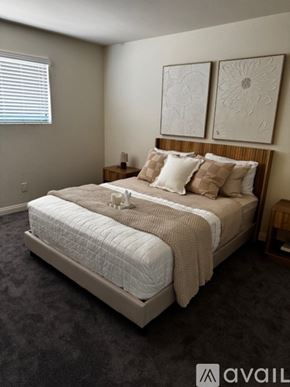 Sierra Vista apartment for rent - A bedroom with a large bed and two wall art pieces.
