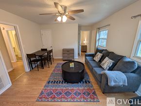 Asheville apartment for rent - A room with a ceiling fan and wooden flooring.