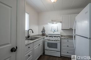 Odessa apartment for rent - A kitchen with white appliances and cabinets.