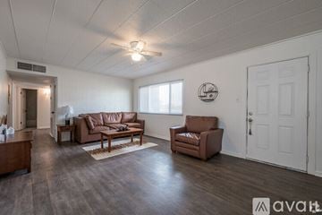 Odessa apartment for rent - A living room with brown leather furniture and a white door.