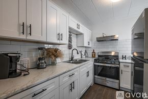 Odessa apartment for rent - A kitchen with white cabinets and stainless steel appliances.