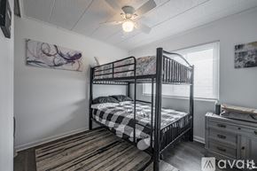 Odessa apartment for rent - A bedroom with a black metal bunk bed and a dresser.