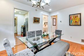 Atlanta apartment for rent - A modern dining room with a glass table and grey chairs.