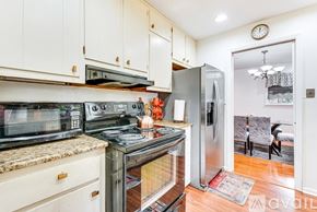 Atlanta apartment for rent - A kitchen with white cabinets and a stainless steel refrigerator.