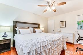 Atlanta apartment for rent - A bedroom with a large bed and a ceiling fan.