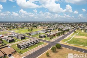 Odessa apartment for rent - A large building complex with a parking lot in front of it.