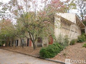 Dalton apartment for rent - A building with the words "Sweetwater Springs" on the side is surrounded by trees and bushes.