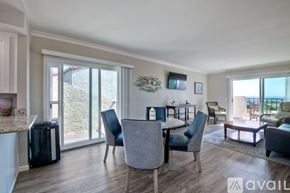 Carlsbad apartment for rent - A modern dining room with a table set for four and a view of the outdoors.