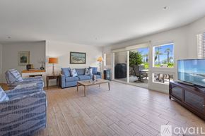 Oceanside apartment for rent - A kitchen with a table and chairs in the middle of the room.