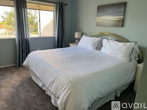 Carlsbad apartment for rent - A bedroom with a large bed and a painting on the wall.