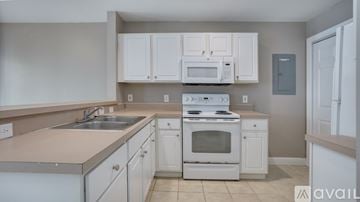 Bluffton apartment for rent - A kitchen with white cabinets and appliances.