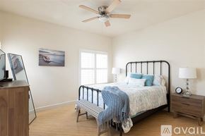 Oceanside apartment for rent - A bedroom with a bed, nightstand, and a ceiling fan.