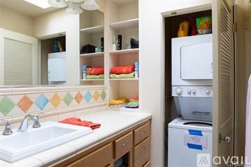 Oceanside apartment for rent - A kitchen with a white sink and a white refrigerator.
