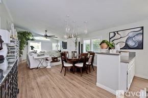 Oceanside apartment for rent - A kitchen with a dining table and chairs.