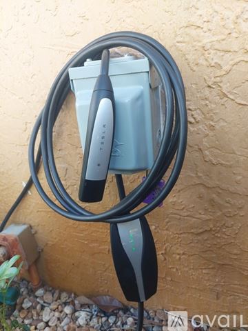 Hialeah house for rent - A black refrigerator in a kitchen with a white wall and a tile floor.