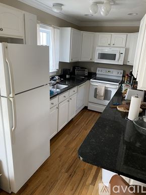 Stamford apartment for rent - A kitchen with white appliances and wooden floors.