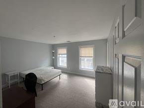 Stamford apartment for rent - A bedroom with a bed, nightstand, and window.