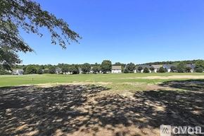 Raleigh apartment for rent - A golf course with a clear blue sky and trees in the distance.