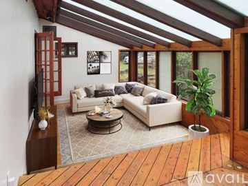 Shelton house for rent - A living room with a couch, coffee table, and a TV on a wooden stand.