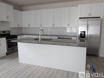 Clearwater apartment for rent - A kitchen with white cabinets and a marble countertop.