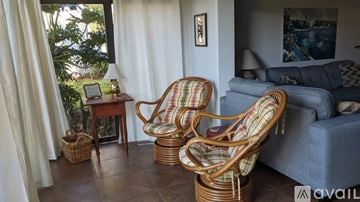 Sarasota condo for rent - Two wicker chairs are placed in a living room.