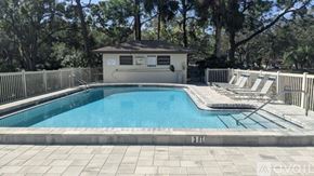 Sarasota condo for rent - A pool with a small building next to it.