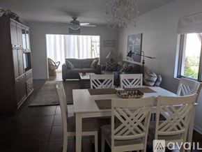 Sarasota condo for rent - A dining room with a table set for four.
