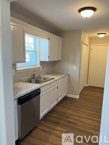 Columbia apartment for rent - A kitchen with white cabinets and a wooden floor.