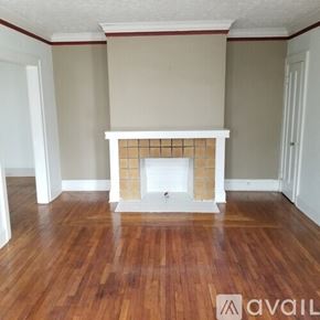 Cleveland Heights apartment for rent - A room with a fireplace and wooden floors.