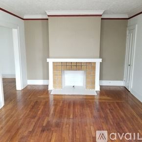 Cleveland Heights apartment for rent - A room with a fireplace and wooden floors.