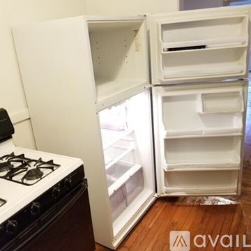 Cleveland Heights apartment for rent - A white refrigerator with its door open is in a kitchen.