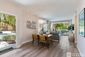 La Quinta house for rent - A dining room with a table set for four and a chandelier hanging from the ceiling.
