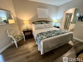La Quinta house for rent - A bedroom with a large bed and a chair.