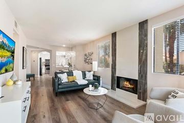 La Quinta house for rent - A living room with a fireplace and a painting on the wall.