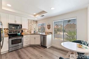 La Quinta house for rent - A kitchen with a table and chairs in front of a window.