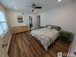 Winter Haven house for rent - A bedroom with a bed, dresser, and ceiling fan.