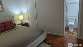 Miami apartment for rent - A bedroom with a bed, nightstand, and lamp.