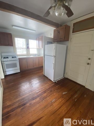Gainesville apartment for rent - A kitchen with wooden floors and white appliances.